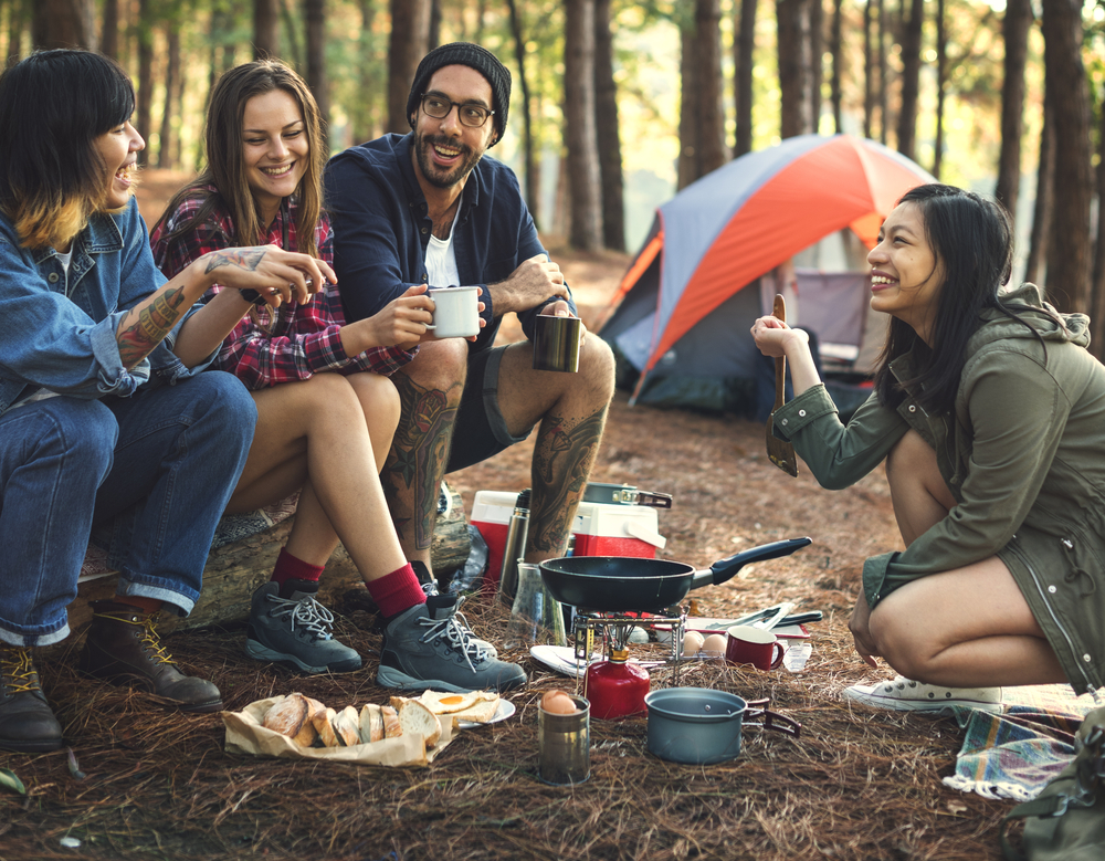 People laughing and talking while camping.
