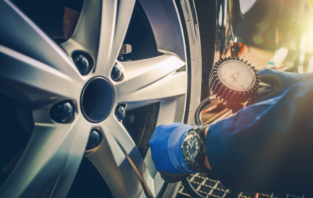 Car tire pressure check in auto service garage.