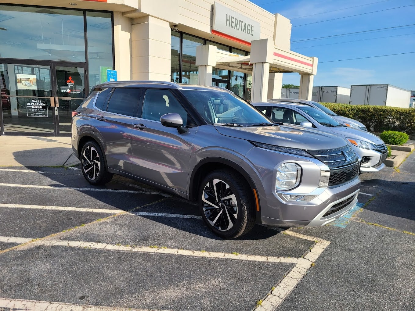 Silver Mitsubishi Outlander in front of Heritage Mitsubishi-Morrow Dealership